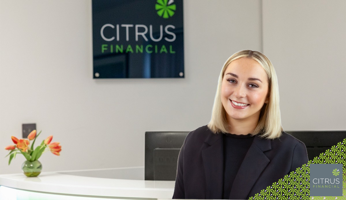 Phoebe Mills standing at the reception desk at Citrus Financial