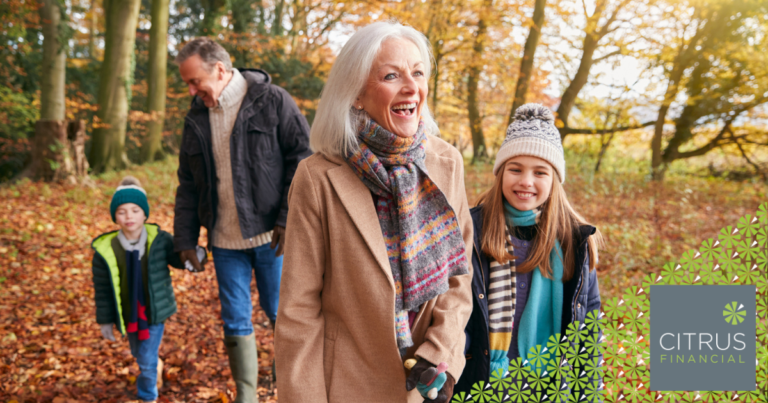 grandparents walking in a wood in Autumn with two grandchildren