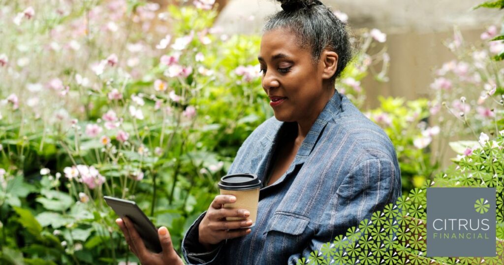 Mature woman on a bench reading an e-book, representing secure online activity and protection against scams in 2025.