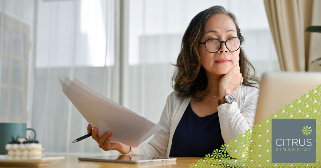 woman reviewing her pension documentation at home