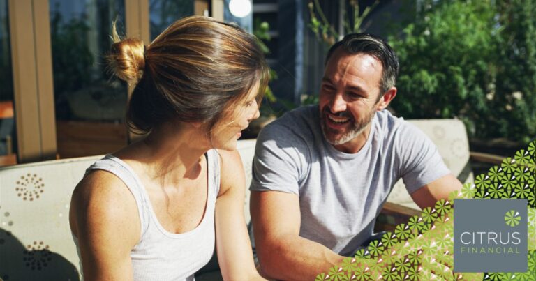Couple talking in the sunshine about their finances