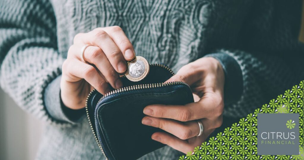Person CAREFULLY PUTTING MONEY IN THEIR PURSE
