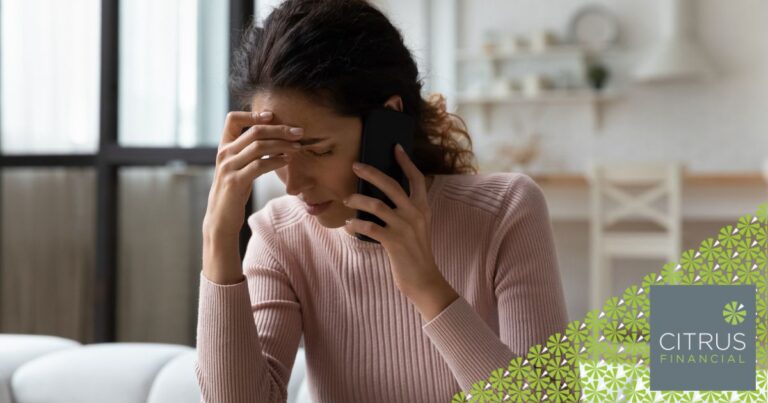 Mother looking concerned while speaking on the phone at home