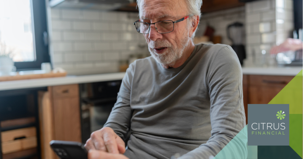 Male retiree looking concerned while checking his phone